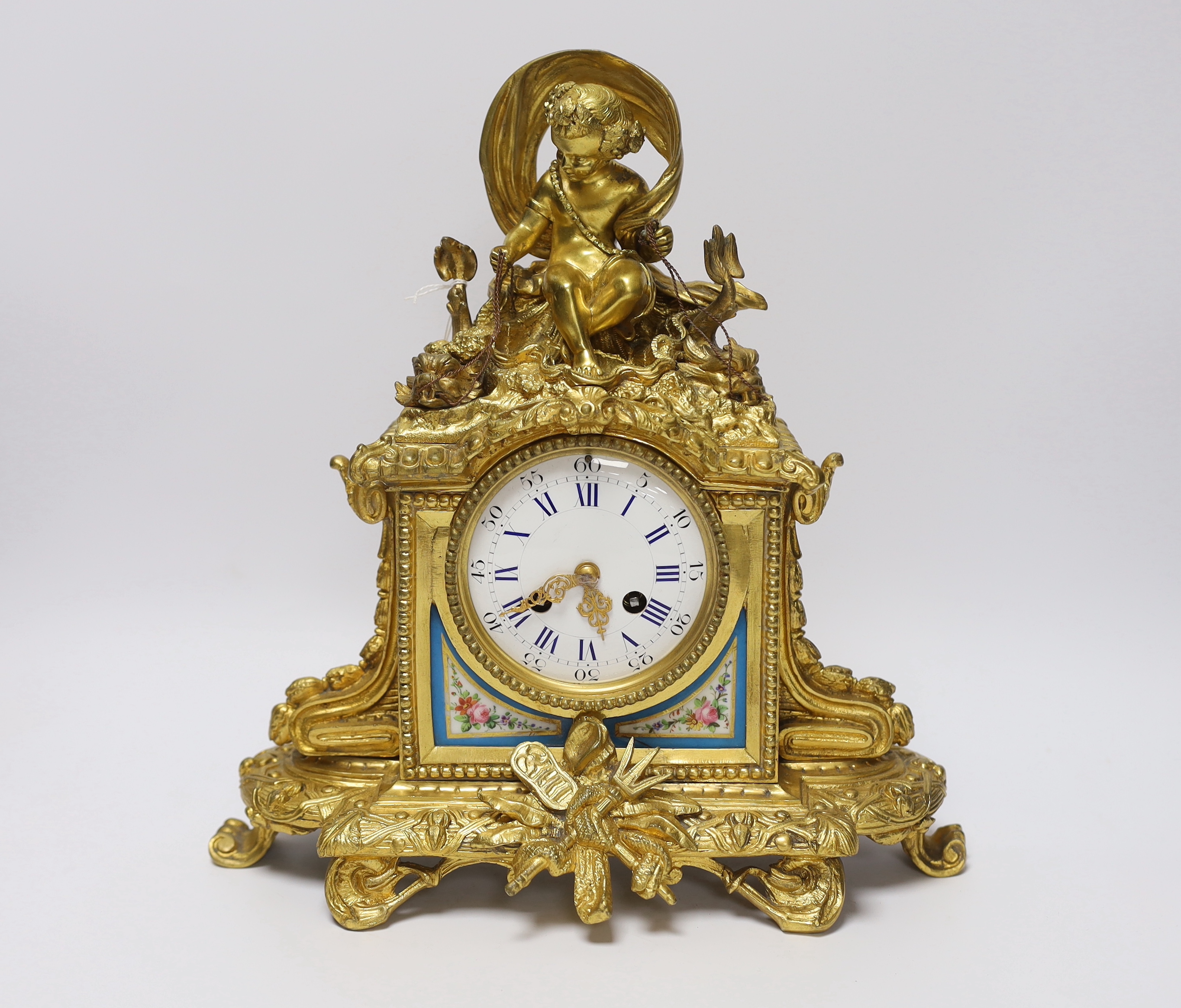 An early 20th century French ormolu mantel clock, with enamel dial, key and pendulum, 31cm